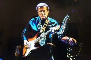 A man playing an electric guitar.
